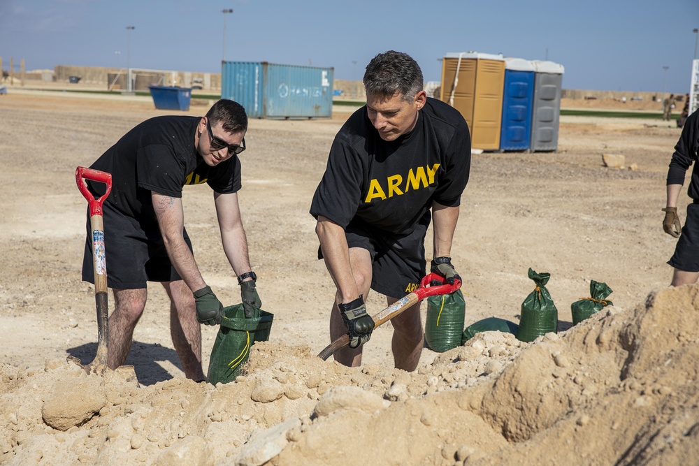 Soldiers fill sandbags and increase force protection measures