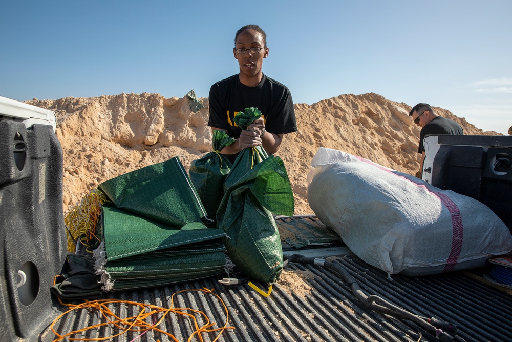 Soldiers fill sandbags and increase force protection measures