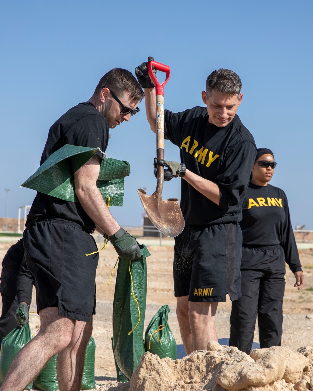 Soldiers fill sandbags and increase force protection measures