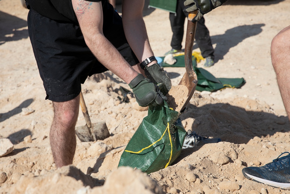 Soldiers fill sandbags and increase force protection measures