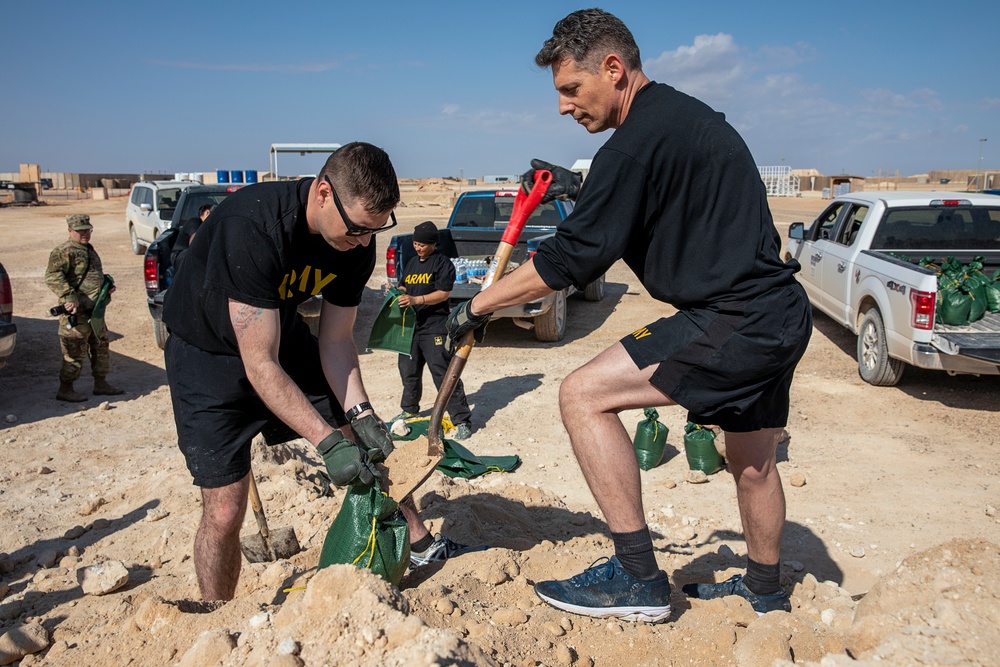 Soldiers fill sandbags and increase force protection measures