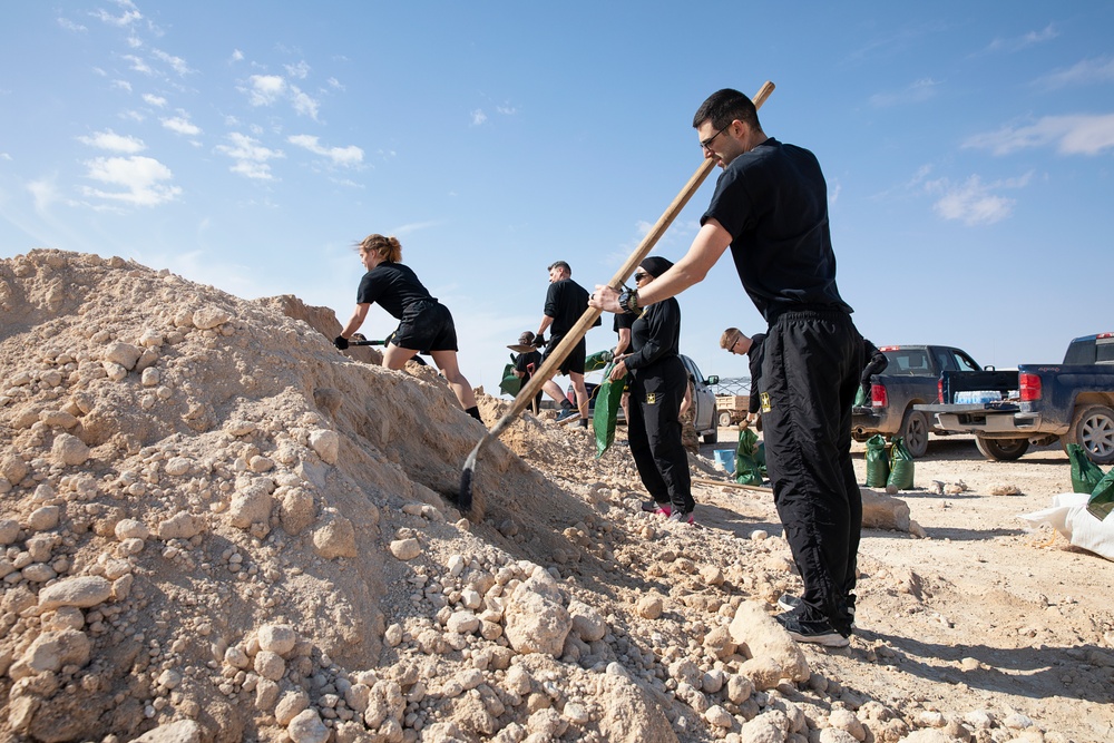 Soldiers fill sandbags and increase force protection measures