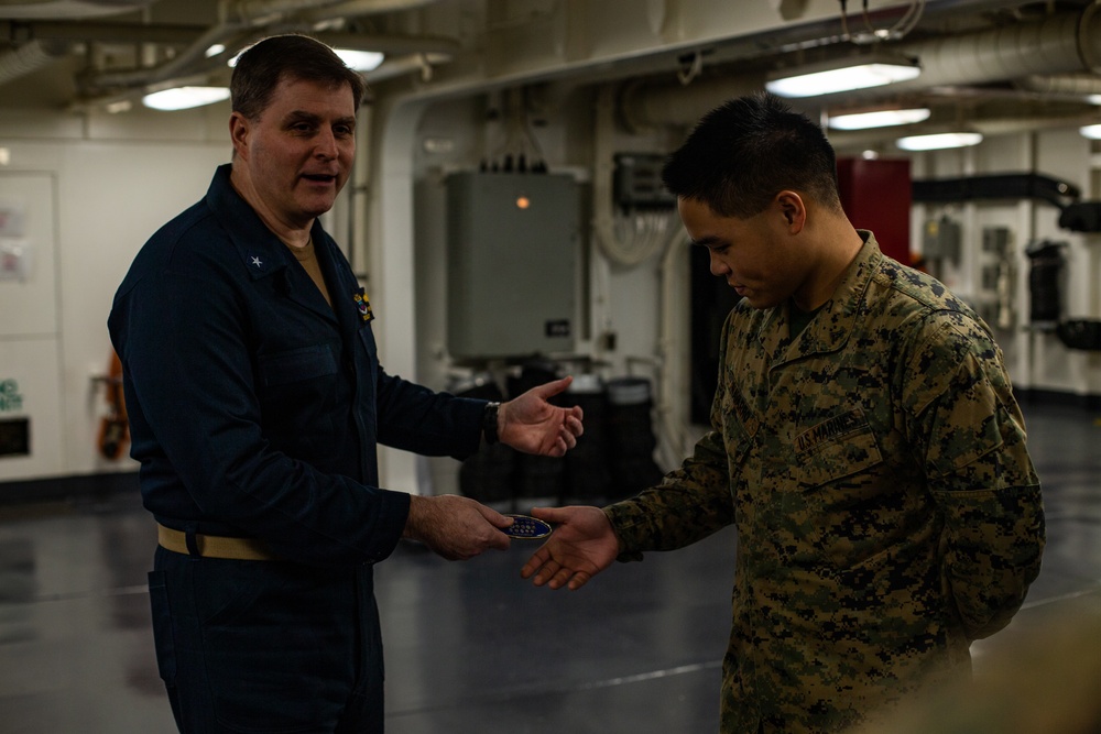 31st MEU Marine awarded by Rear Adm. Kacher aboard USS America