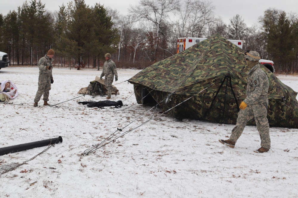 Cold-Weather Operations Course students build Arctic tents during training