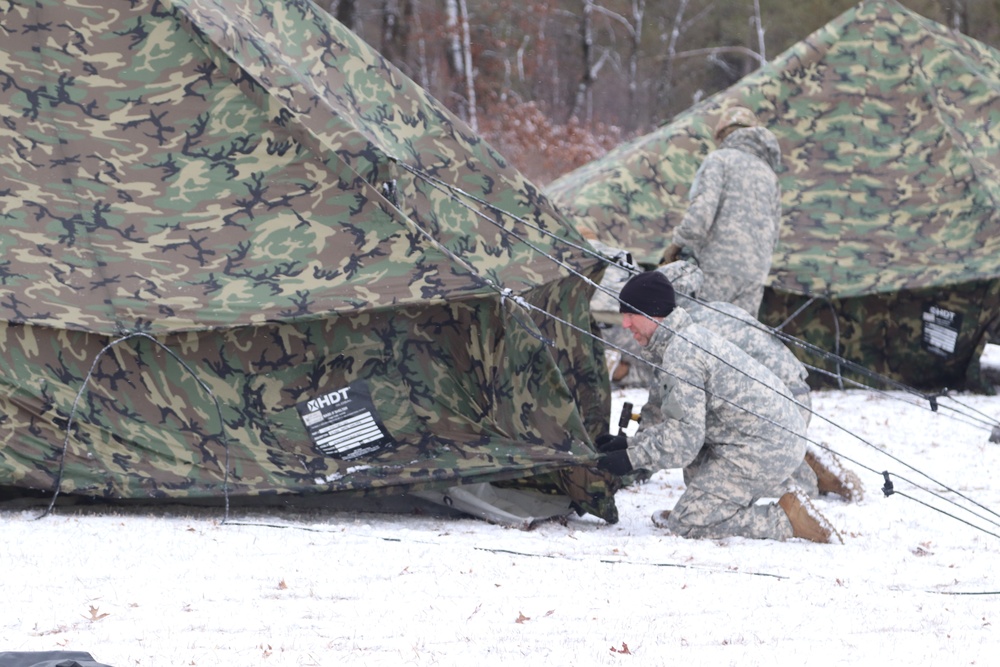 Cold-Weather Operations Course students build Arctic tents during training