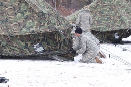 Cold-Weather Operations Course students build Arctic tents during training