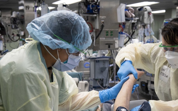 U.S. Navy Doctors, Nurses and Corpsmen Treat COVID Patients in the ICU Aboard USNS Comfort
