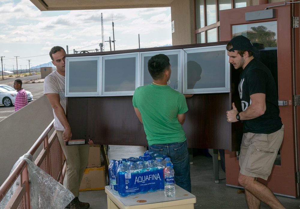 Marines, fire fighters &amp; families volunteer to move NMCRS Thrift Store