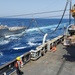 USNS Supply sends fuel probe during refueling-at-sea with USS Porter