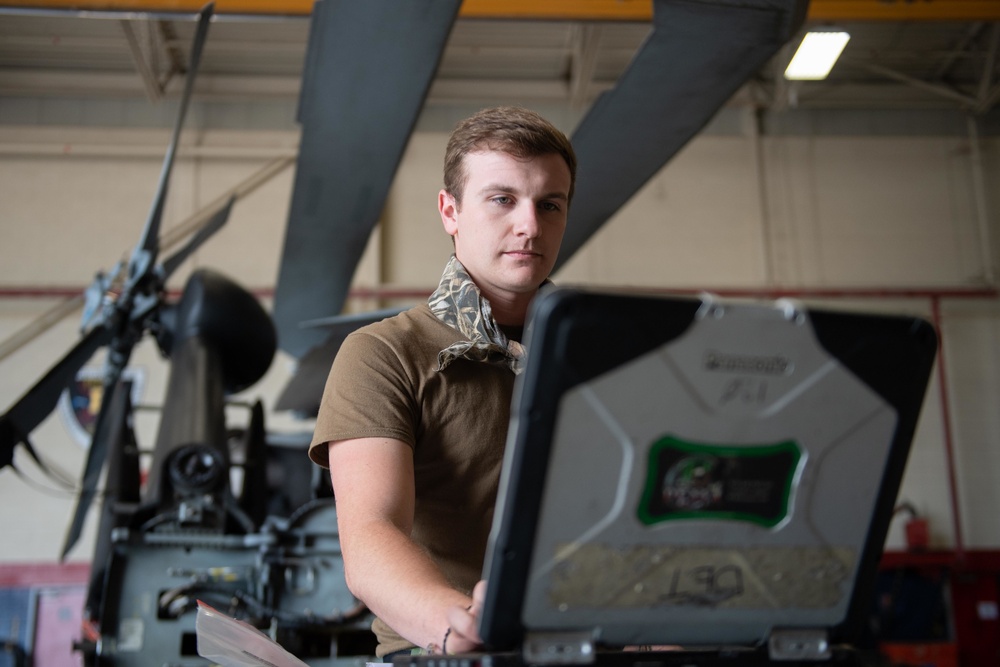 Sailor does maintenance on MH-60S Sea Hawk