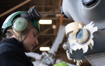 Sailor does maintenance on MH-60S Sea Hawk