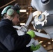 Sailor does maintenance on MH-60S Sea Hawk