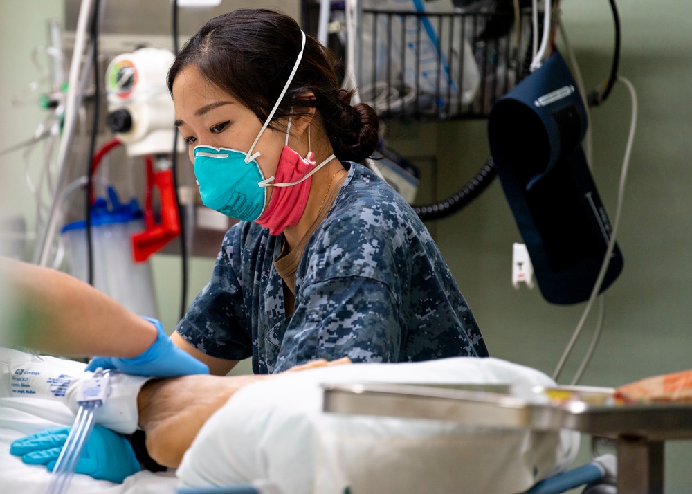 USNS Mercy Sailor Treats Patient