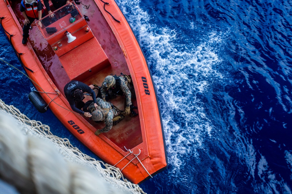 Marines conduct tactical cargo net debarkation from amphibious assault ship USS America (LHA 6).