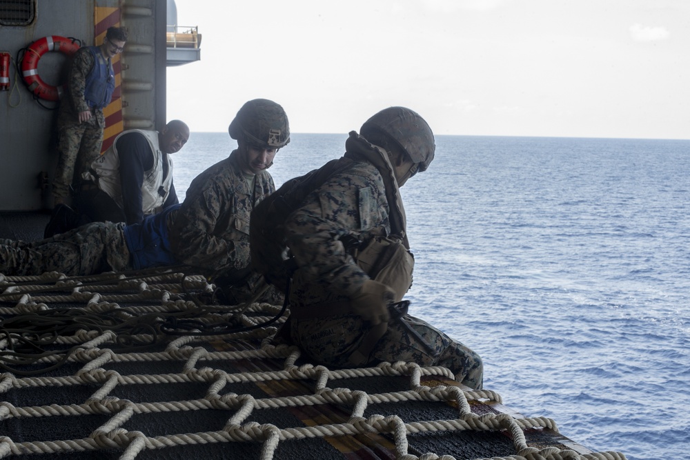 Marines conduct tactical cargo net debarkation from amphibious assault ship USS America (LHA 6).