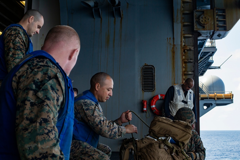 Marines conduct tactical cargo net debarkation from amphibious assault ship USS America (LHA 6).