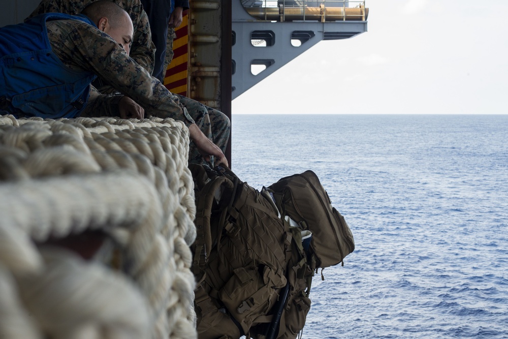 Marines conduct tactical cargo net debarkation from amphibious assault ship USS America (LHA 6).