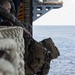 Marines conduct tactical cargo net debarkation from amphibious assault ship USS America (LHA 6).