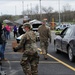 Soldier works with Community Voluteers to Load Trunks with Food