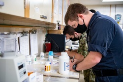USNS Mercy Sailors Work in Pharmacy [Image 1 of 3]