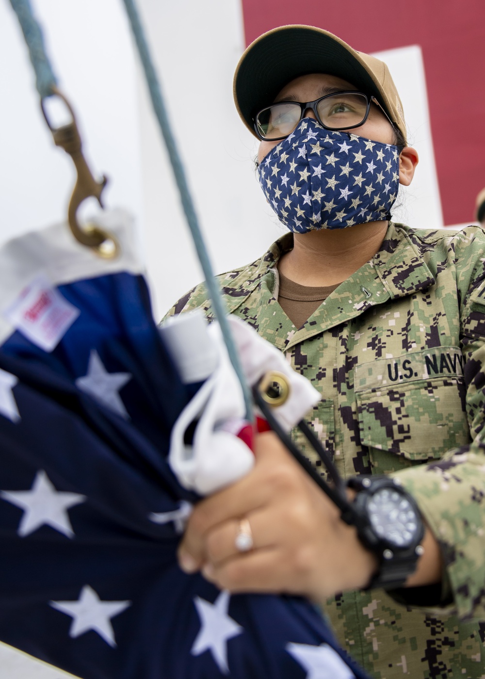 USNS Mercy Sailor Prepares to Raise the National Ensign