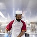 USNS Mercy Sailor Prepares Meal