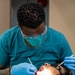 USNS Mercy Sailor Performs Dental Assessment