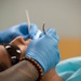 USNS Mercy Sailor Performs Dental Assessment
