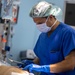 USNS Mercy Sailor Inspects Staples