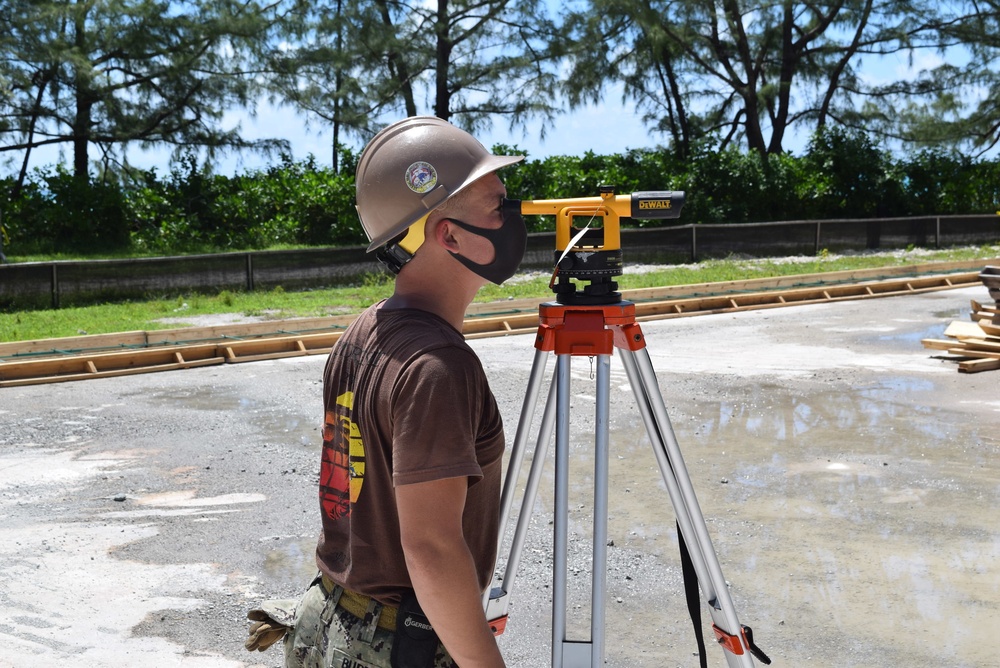 U.S. Navy Seabees from NMCB 5’s Detail Diego Garcia place concrete in support of the U.S. Air Force