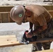 U.S. Navy Seabees from NMCB 5’s Detail Diego Garcia place concrete in support of the U.S. Air Force