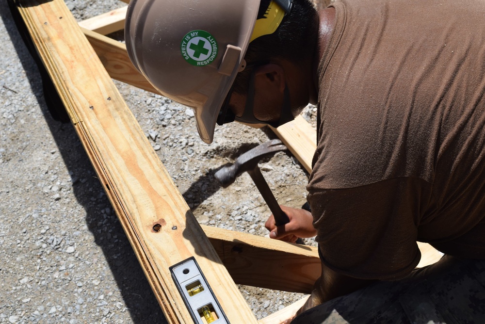 U.S. Navy Seabees from NMCB 5’s Detail Diego Garcia place concrete in support of the U.S. Air Force