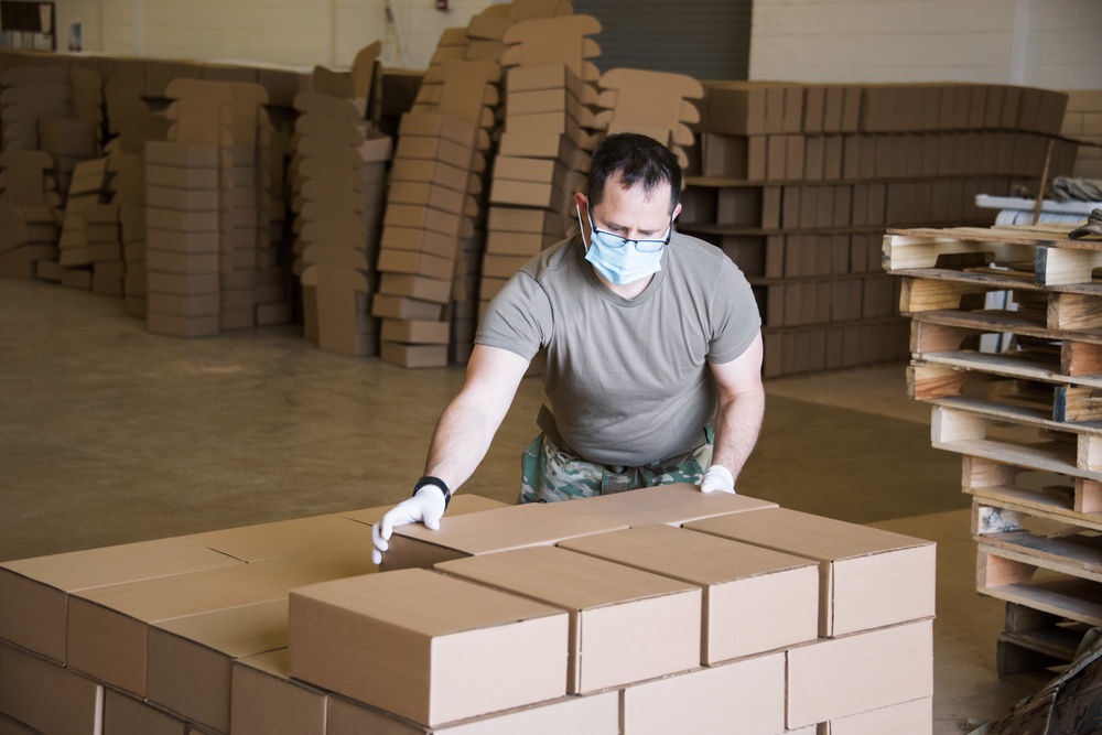 Kansas Army National Guard Soldiers prepare hunger relief boxes for Wichita Food Bank