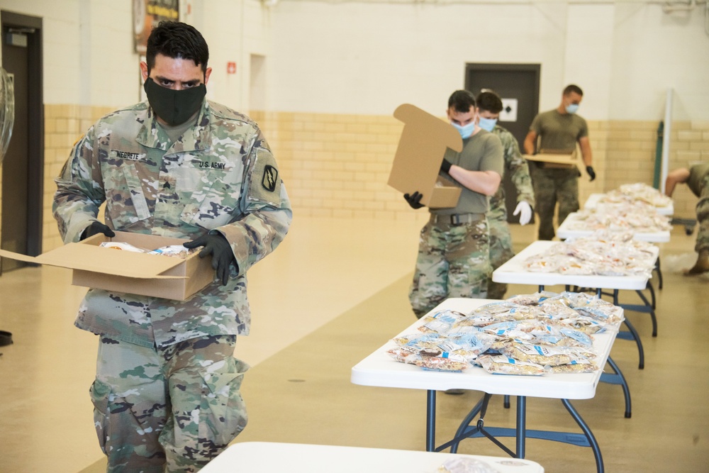 Kansas Army National Guard Soldiers prepare hunger relief boxes for Wichita Food Bank