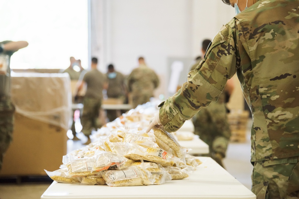 Kansas Army National Guard Soldiers prepare hunger relief boxes for Wichita Food Bank