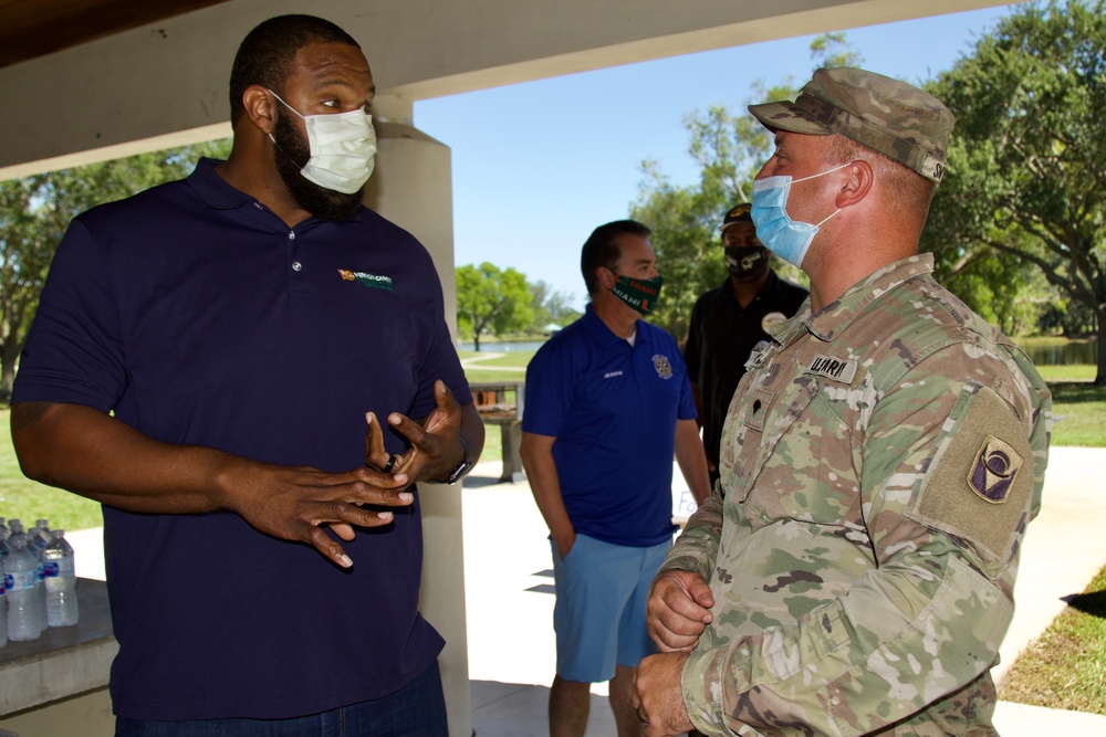 Local partners and the Florida National Guard share a meal