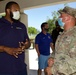 Local partners and the Florida National Guard share a meal