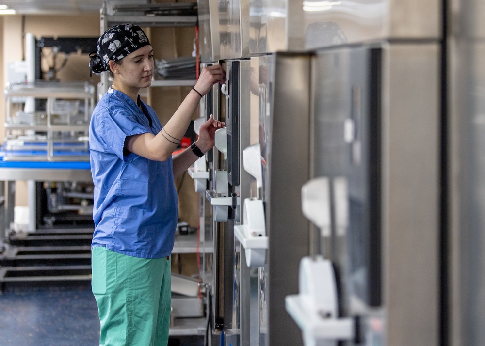 USNS Mercy Sailor Monitors a Steam Sterilizer