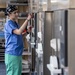 USNS Mercy Sailor Monitors a Steam Sterilizer