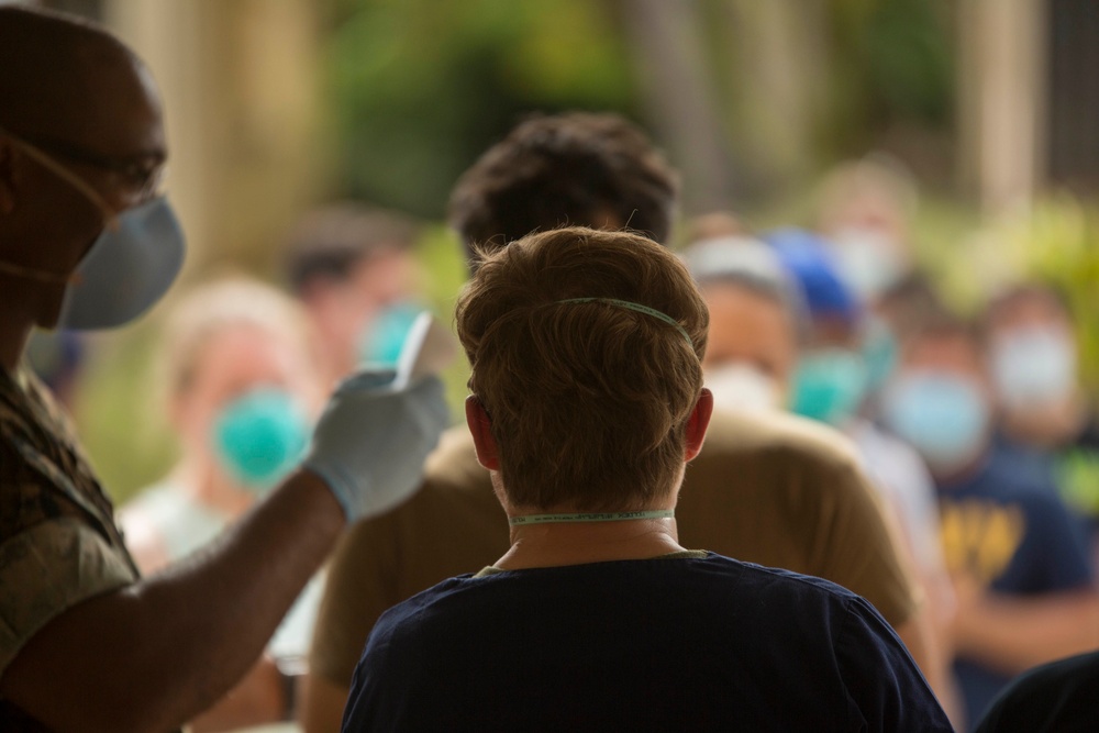 3rd Medical Battalion staff check USS Theodore Roosevelt Sailors for COVID-19 symptoms
