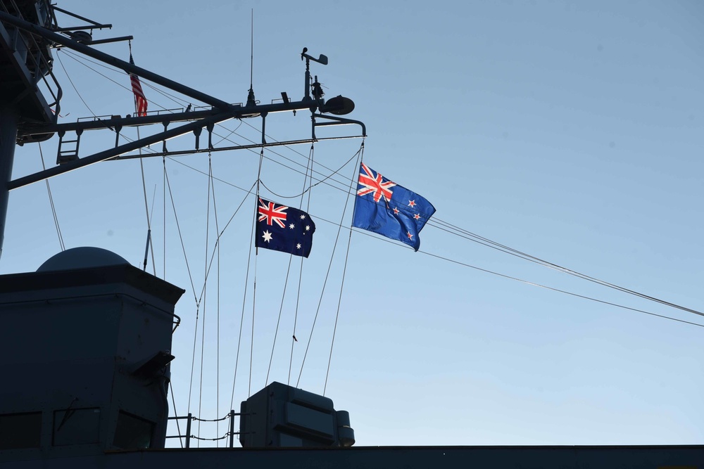 Flags from Australia and New Zealand are hoisted during the 105th Australian and New Zealand Army Corps (ANZAC) Day ceremony