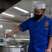 USNS Mercy Sailor Stirs Pasta