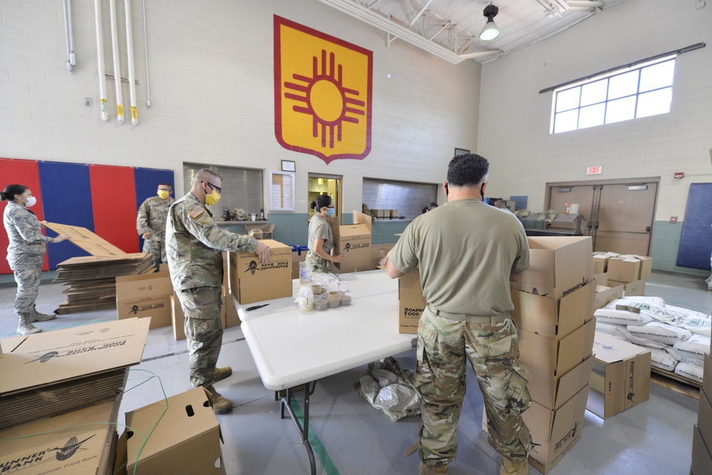Airmen and Soldiers from the New Mexico National Guard Joint Task Force package food in response to COVID-19