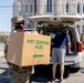 Soldiers load donated groceries