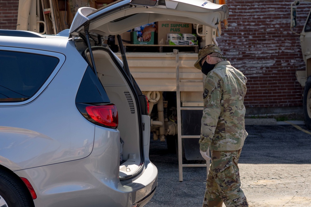 Soldiers load donated groceries