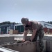 U.S. Navy Seabees deployed with NMCB-5’s Detail Sasebo are construct buildings for Naval Beach Unit 7