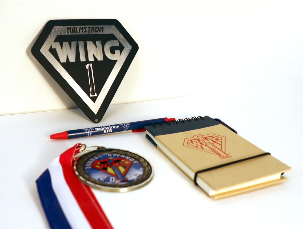 Wing One Rebranding Magnet, pen, medal, and notepad