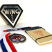 Wing One Rebranding Magnet, pen, medal, and notepad