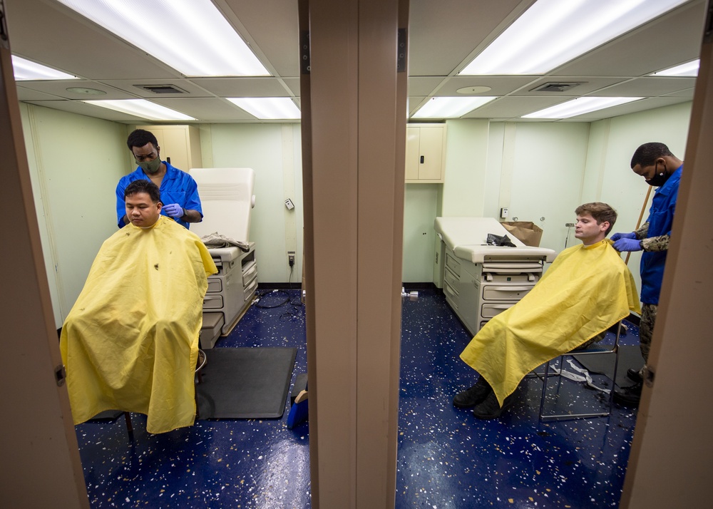 USNS Mercy Sailors Receive Haircuts