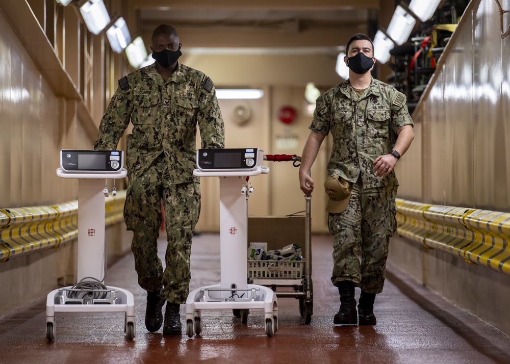 USNS Mercy Sailors Transport Medical Equipment